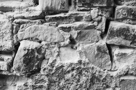 Gray art texture of a old stonewall. The background surface is a big natural stones. High quality photoの写真素材