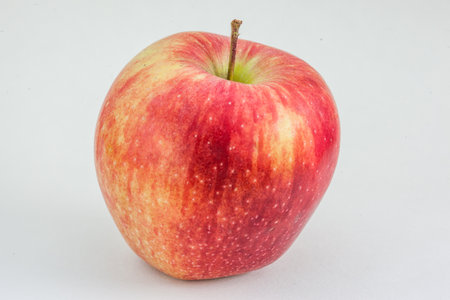 Red apple on a light gray background. Organic fruit, healthy eating, diet, lifestyle concept, treatment choice concept. Non - GMO. High-quality photoの写真素材