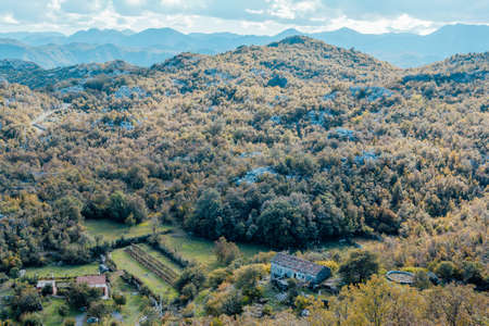 Aerial panoramic view of landscape of green mountains and blue sky with white clouds. The horizontal landscape in mountains. Travel trip background for a poster, wallpaper, postcard, banner, coverの写真素材