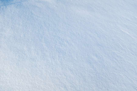 Light blue winter background of smooth snow wall. Vertical snow backdrop for poster, calendar, post, screensaver, wallpaper, postcard, card, banner, cover, header for website. High quality photoの写真素材