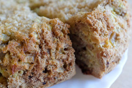 A pieces of apple pie on a white plate, close-up. Homemade bakery. Charlotte pie for publication, design, poster, calendar, post, screensaver, wallpaper, postcard, card, banner, cover, websiteの写真素材