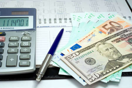 composition - pen, calculator and banknote