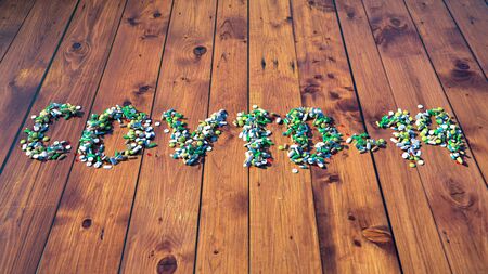 The inscription Covid-19 from tablets on a wooden boardの写真素材