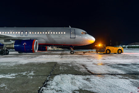 Close-up with high detail of a large wide-body passenger aircraft standing in the airport parking...