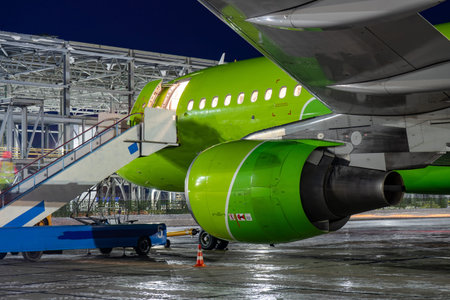 Close-up with high detail of a large wide-body passenger aircraft standing in the airport parking...