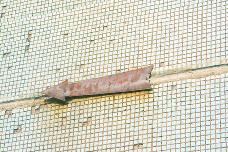 Trowel on a metal mesh in a construction site. toned.の写真素材