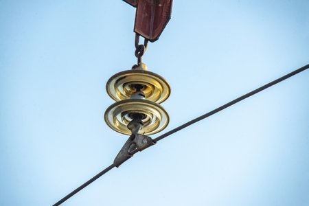 electric pole on a blue sky background, power transmission pole with green insulatorの写真素材