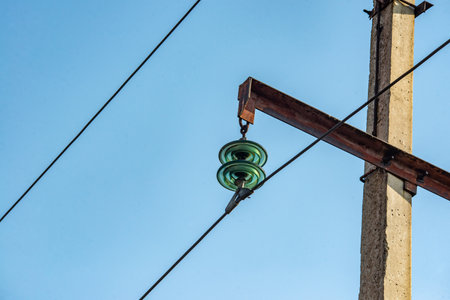 electricity post with blue sky background, power pole with green lampの写真素材