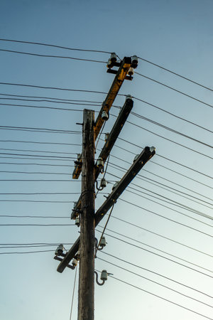 electricity post with blue sky background, power pole with electrical wiresの写真素材