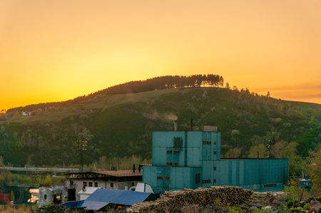 Abandoned factory on the hill at sunset in the mountains.の写真素材