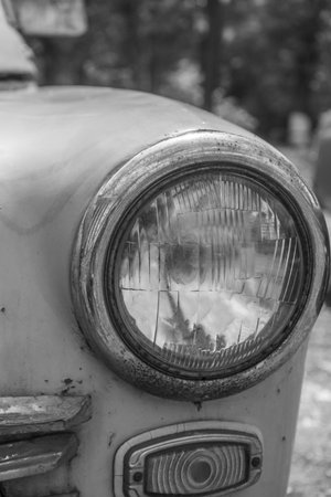 Headlight of an old classic car. black and white picture.