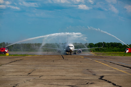 Airplane spraying water on the runway of the airport in the summer