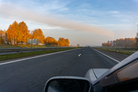 Driving on a highway in autumn. View from the car.の写真素材