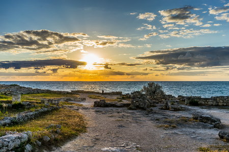 Sunset over the sea in the ancient Chersonesos among the ruins and buildingsの写真素材