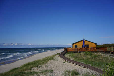 Seascape with a cosy wooden house on the shore of the Baltic seaの写真素材