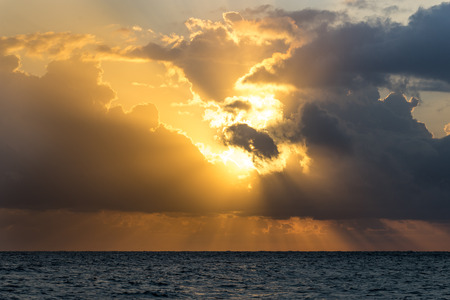 Natural landscape with dramatic sunset on the background of the calm blue seaの写真素材