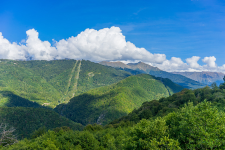Mountain landscape against cloudy blue sky in Krasnaya Polyana Sochiの写真素材