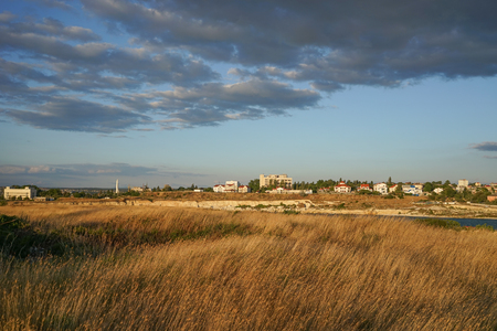 steppe suburbs of the city of Sevastopol with the bleached grass under blue skyの写真素材
