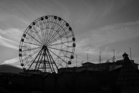 Sochi. Russia. January 7, 2018. A Ferris wheel with lots of booths in the amusement Park of Sochi on the background of the sky.のeditorial素材