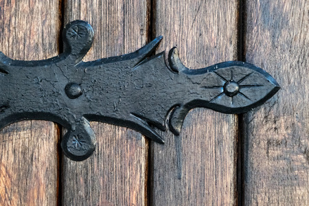 black metal decorative element on wooden doorsの写真素材