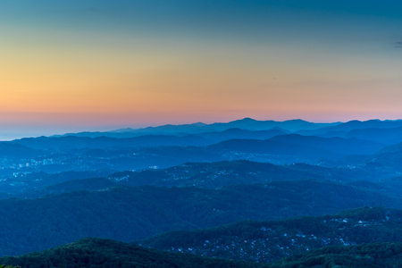 Mountain landscape with several rows of hills at sunset.の写真素材