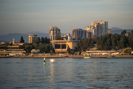 Sochi. Russia. 08 Oct 2016. View from the sea in the Central promenade of the city with a summer concert hall "Festival" in the background high-rise buildings and mountains.のeditorial素材