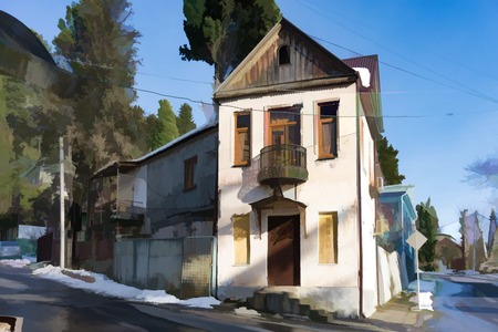 House with ancient architecture and a balcony in a narrow street of Sukhumi. in clear winter weather.の写真素材