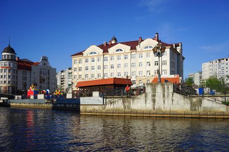 Kaliningrad, Russia - May 11, 2016: The modern landmark of the city with the lighthouse and buildings in the old style on the banks of the Pregolya river.のeditorial素材