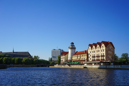 Kaliningrad, Russia - May 11, 2016: The modern landmark of the city with the lighthouse and buildings in the old style on the banks of the Pregolya river.のeditorial素材
