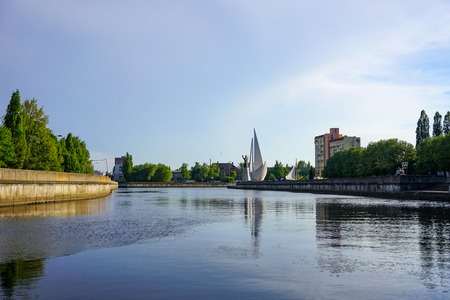 Kaliningrad, Russia - May 11, 2016: Cityscape with view of the river, a monument to Saint Nicholas and modern buildings.のeditorial素材