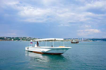 Sevastopol, Crimea-June 14, 2015: Seascape with sailing ships against the horizon and blue sky.のeditorial素材