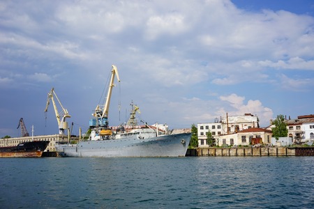 Sevastopol, Crimea-June 14, 2015: Seascape with ships at the pier against the horizon and the blue sky.のeditorial素材