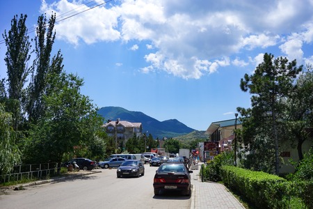 Koktebel, Crimea-June 27, 2015: The road to the resort town of Koktebel surrounded by trees and rest of people.のeditorial素材