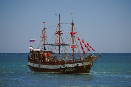 Koktebel, Crimea-June 27, 2015: Tourist ship in vintage style on the background of blue sea and horizon.のeditorial素材