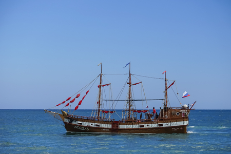 Koktebel, Crimea-June 27, 2015: Tourist ship in vintage style on the background of blue sea and horizon.のeditorial素材