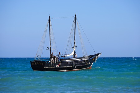 Koktebel, Crimea-June 27, 2015: Tourist ship in vintage style on the background of blue sea and horizon.のeditorial素材
