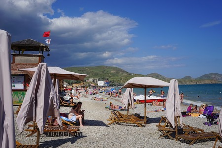 Koktebel, Crimea-June 27, 2015: Beach area of a small resort town with resting people.のeditorial素材