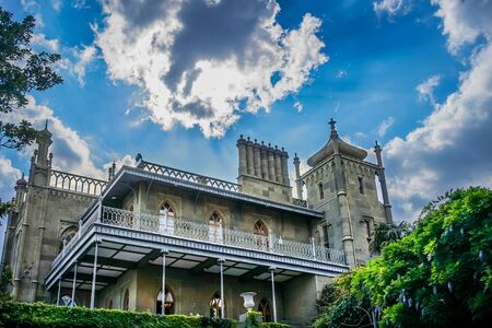 Yalta, Crimea - June 22, 2015: The architecture of the Vorontsov Palace with beautiful vegetation on the background of blue sky.のeditorial素材