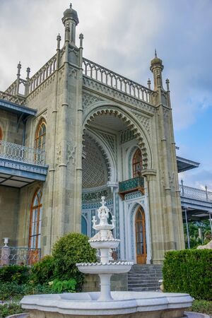 Yalta, Crimea - June 22, 2015: The architecture of the Vorontsov Palace with beautiful vegetation on the background of blue sky.のeditorial素材