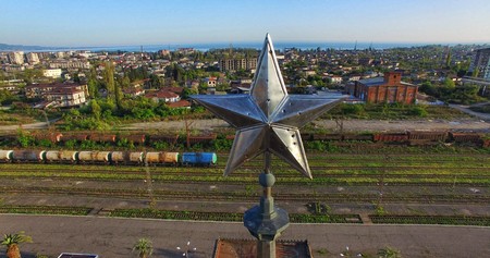Spire of the train station building in the form of a star against the urban landscape. Sukhumi, Abkhaziaの写真素材