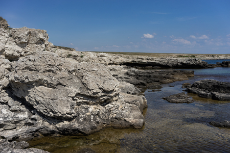 Rocks and stones against the sea under the blue sky at Cape Tarkhankut in the Crimea.の写真素材