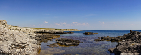 Rocks and stones against the sea under the blue sky at Cape Tarkhankut in the Crimea.の写真素材