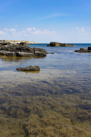 Rocks and stones against the sea under the blue sky at Cape Tarkhankut in the Crimea.の写真素材