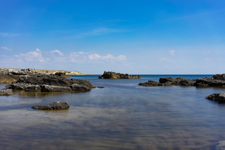Rocks and stones against the sea under the blue sky at Cape Tarkhankut in the Crimea.の写真素材