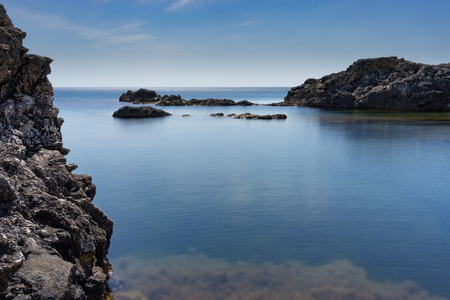 Rocks and stones against the sea under the blue sky at Cape Tarkhankut in the Crimea.の写真素材
