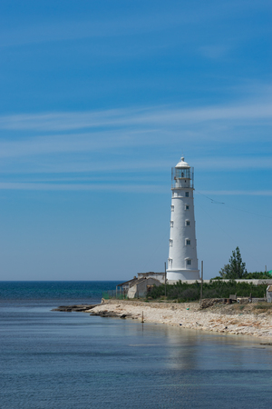 seascape with beautiful white lighthouse against blue sky on Cape Tarkhankut, Crimea.の写真素材