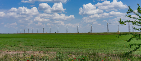 Panorama of wind farms against the blue sky with clouds.の写真素材