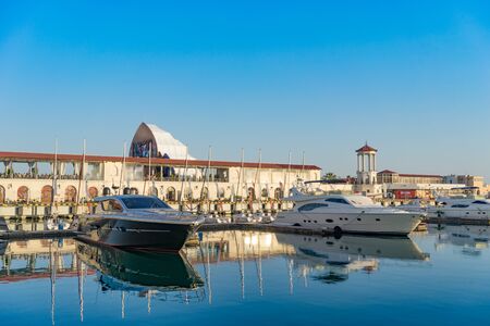 Sochi, Russia-June 14, 2018: Sea port with yacht Parking on the background of the multimedia screen fanzone FIFA -2018.のeditorial素材