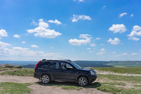 Belogorsk, Crimea-may 22, 2018: Black SUV on a natural landscape backgroundのeditorial素材