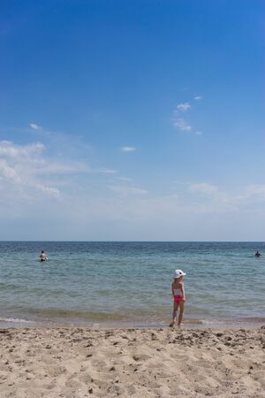 Evpatoria, Crimea-may 23, 2018: The coastline of the city with yellow sand and resting people.のeditorial素材